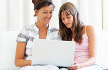 Parent and daughter with a computer